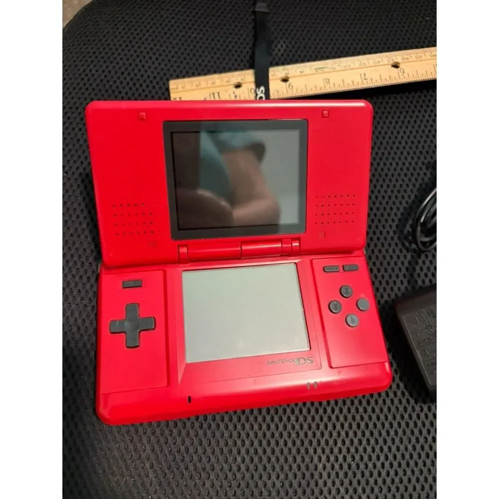 Red nintendo DS with charger and 3 games gently used